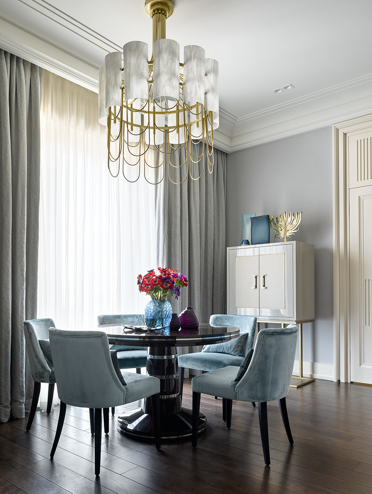 Photo of a transitional dining room in London with grey walls, dark hardwood floors and brown floor.