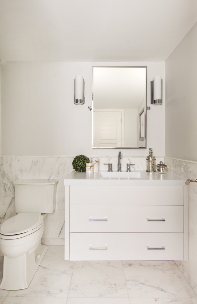 Transitional powder room in Toronto with flat-panel cabinets, white cabinets and marble.