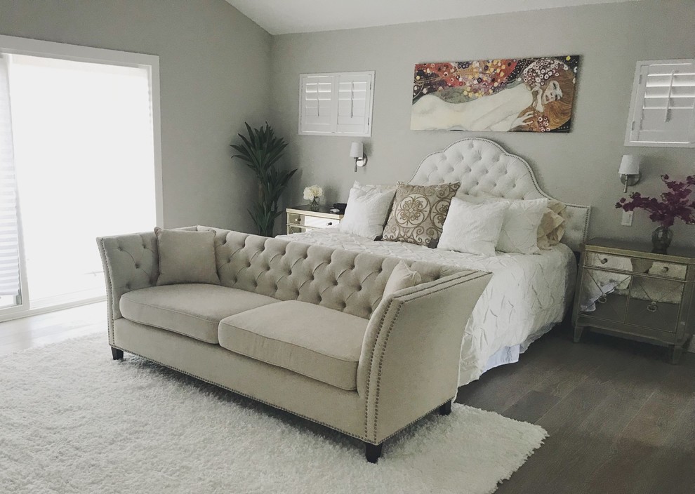This is an example of a large traditional guest bedroom in Los Angeles with grey walls, medium hardwood floors, no fireplace and grey floor.