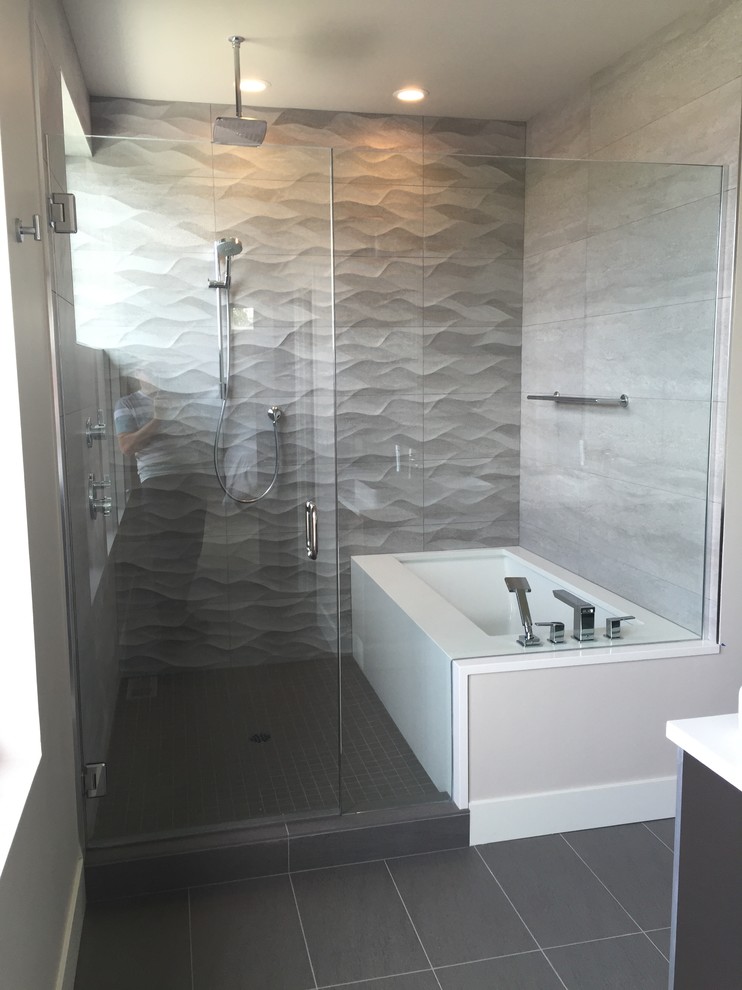 Inspiration for a small contemporary master bathroom in Seattle with flat-panel cabinets, dark wood cabinets, an undermount tub, an alcove shower, beige tile, ceramic tile, grey walls, porcelain floors, a vessel sink, quartzite benchtops, grey floor and a hinged shower door.