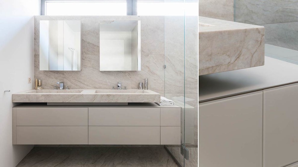 Inspiration for a large contemporary master bathroom in Other with glass-front cabinets, beige cabinets, beige tile, metal tile, an integrated sink, marble benchtops, beige benchtops, a double vanity and a floating vanity.