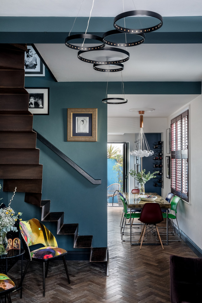 Design ideas for a small bohemian formal open plan living room in London with blue walls, medium hardwood flooring, a standard fireplace, a brick fireplace surround, no tv and brown floors.