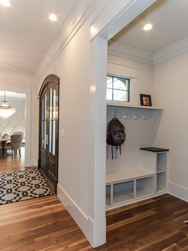 Mid-sized traditional entry hall in Raleigh with white walls, light hardwood floors, a double front door, a dark wood front door and white floor.