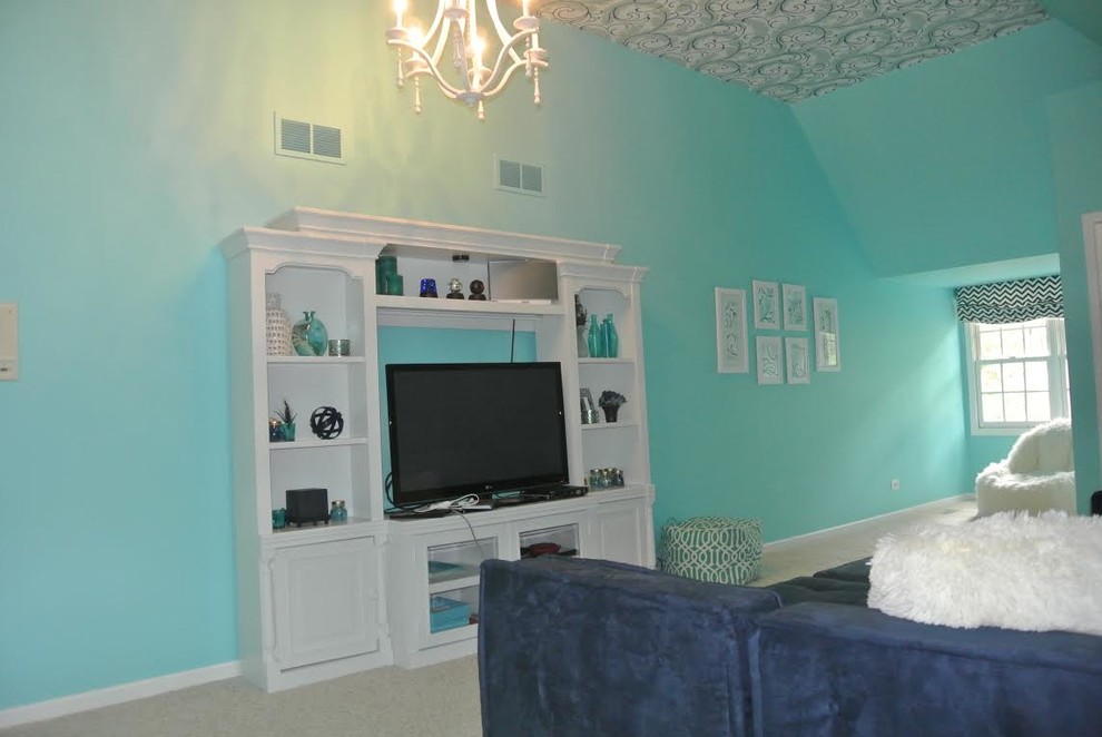 This is an example of a large transitional loft-style bedroom in Chicago with blue walls, carpet and no fireplace.