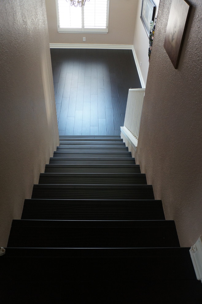 Photo of a mid-sized arts and crafts wood straight staircase in Los Angeles with painted wood risers and wood railing.