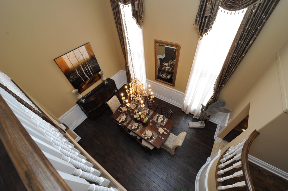 Photo of a mid-sized traditional open plan dining in Toronto with beige walls, dark hardwood floors and brown floor.