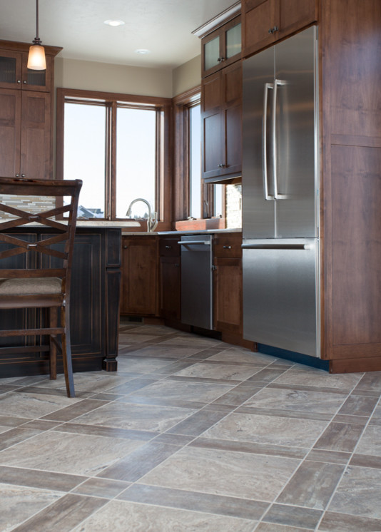 Inspiration for a large transitional u-shaped vinyl floor and brown floor eat-in kitchen remodel with recessed-panel cabinets, dark wood cabinets, granite countertops, multicolored backsplash, glass tile backsplash, stainless steel appliances and an island
