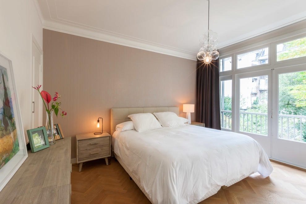 This is an example of a scandinavian master bedroom in Amsterdam with beige walls.
