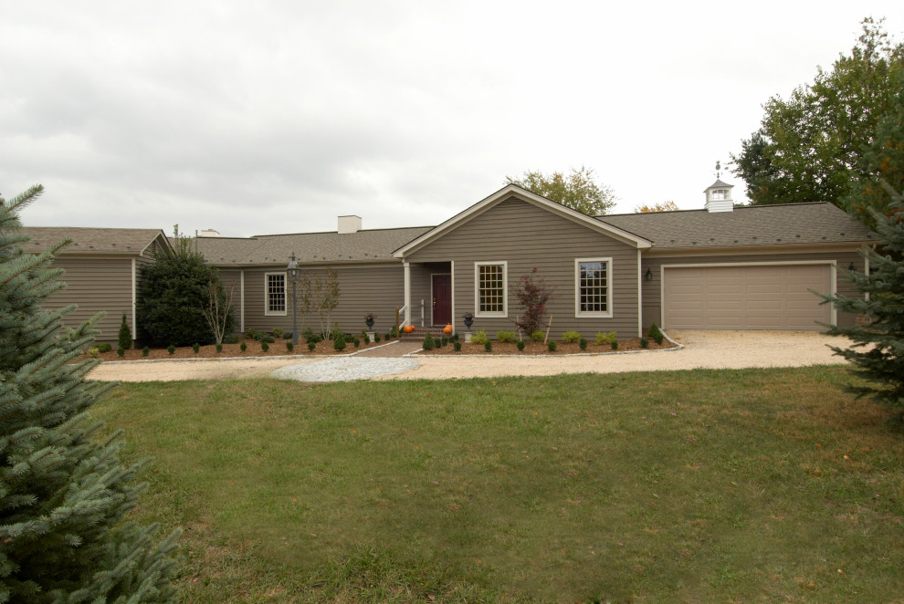 Mid-sized green one-story vinyl house exterior photo with a shingle roof