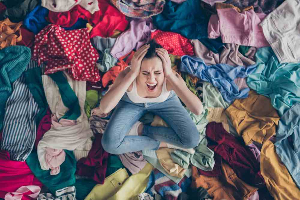 woman stressed over messy closet