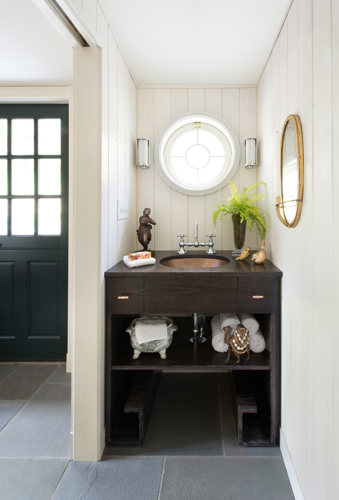 Design ideas for an eclectic powder room in Philadelphia with an undermount sink, flat-panel cabinets and dark wood cabinets.