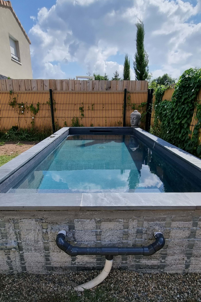 This is an example of a small modern back rectangular above ground swimming pool in Bordeaux with with pool landscaping and decking.