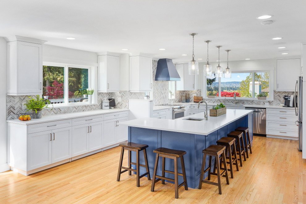 Large transitional l-shaped eat-in kitchen in Seattle with an undermount sink, shaker cabinets, white cabinets, quartz benchtops, multi-coloured splashback, mosaic tile splashback, stainless steel appliances, light hardwood floors, with island and yellow benchtop.