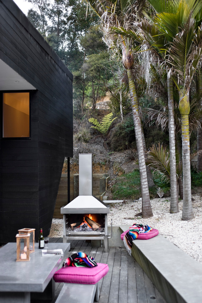 Modern deck in Auckland with a fire feature.