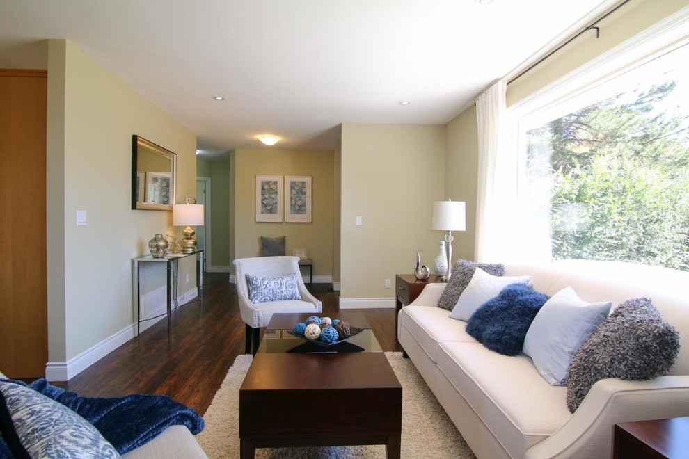 Mid-sized transitional formal open concept living room in Toronto with yellow walls, dark hardwood floors and no tv.