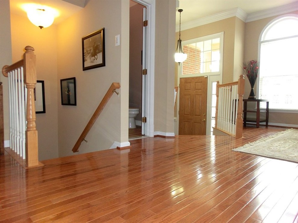 Design ideas for a mid-sized transitional foyer in DC Metro with beige walls, medium hardwood floors, a single front door and a light wood front door.