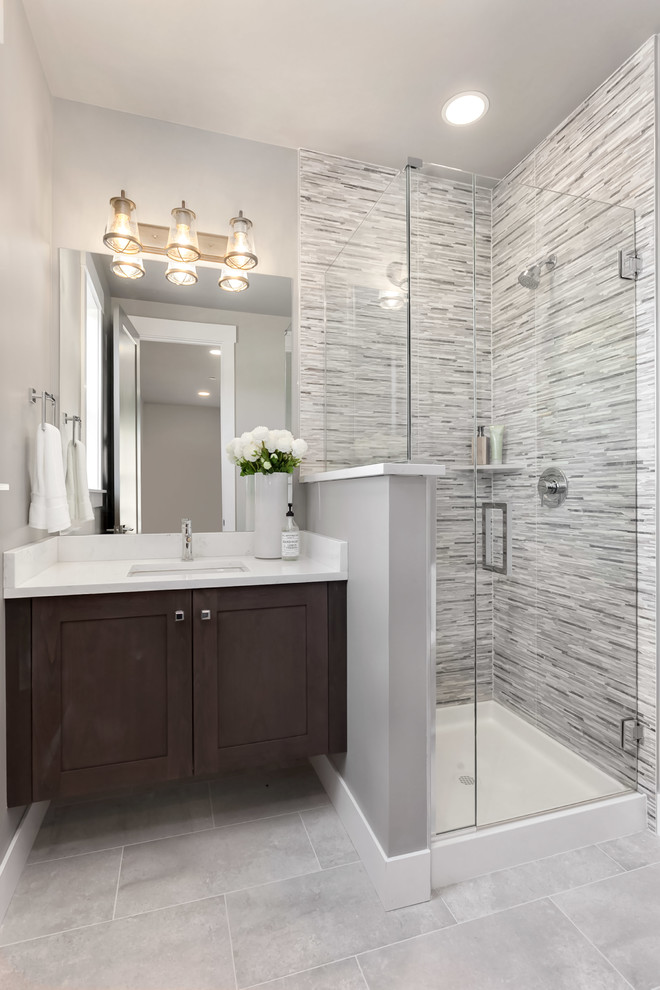 Design ideas for a large contemporary 3/4 bathroom in Seattle with shaker cabinets, medium wood cabinets, a corner shower, a one-piece toilet, an undermount sink, engineered quartz benchtops, a hinged shower door and white benchtops.