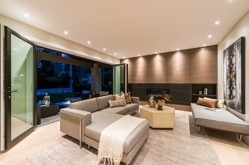Large contemporary formal open concept living room in Vancouver with beige walls, light hardwood floors, a ribbon fireplace, a wood fireplace surround and no tv.