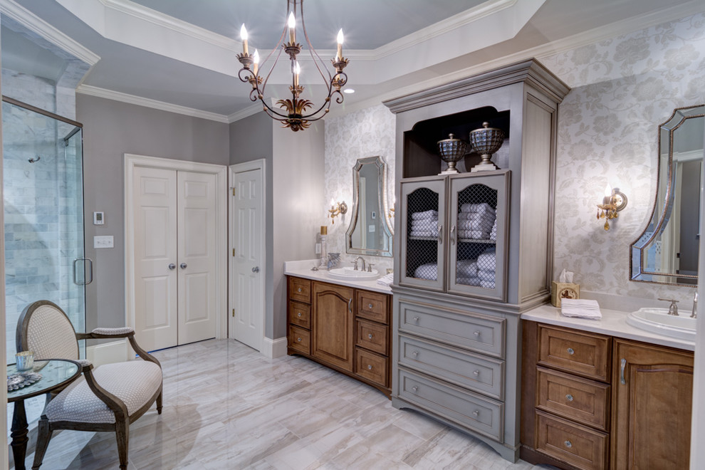 This is an example of a large traditional master bathroom in Atlanta with a drop-in sink, furniture-like cabinets, medium wood cabinets, quartzite benchtops, a freestanding tub, a corner shower, gray tile, stone tile, grey walls, porcelain floors, grey floor and a hinged shower door.