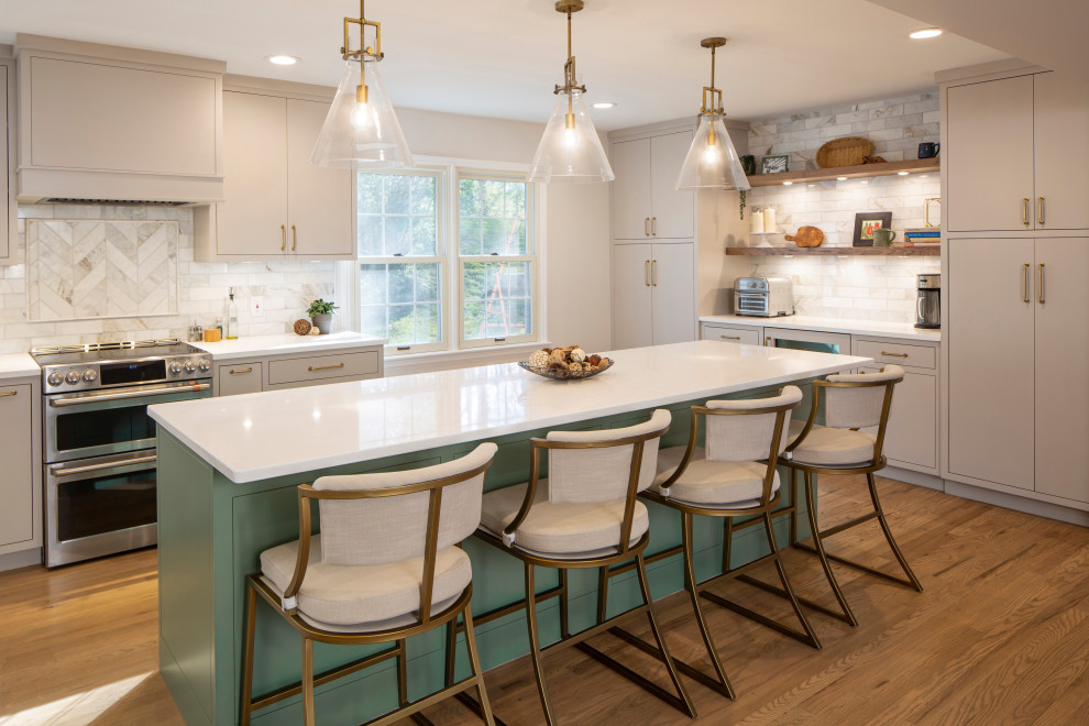 Mid-sized transitional l-shaped medium tone wood floor kitchen photo in Cincinnati with an undermount sink, beige cabinets, quartz countertops, marble backsplash, stainless steel appliances, an island and white countertops