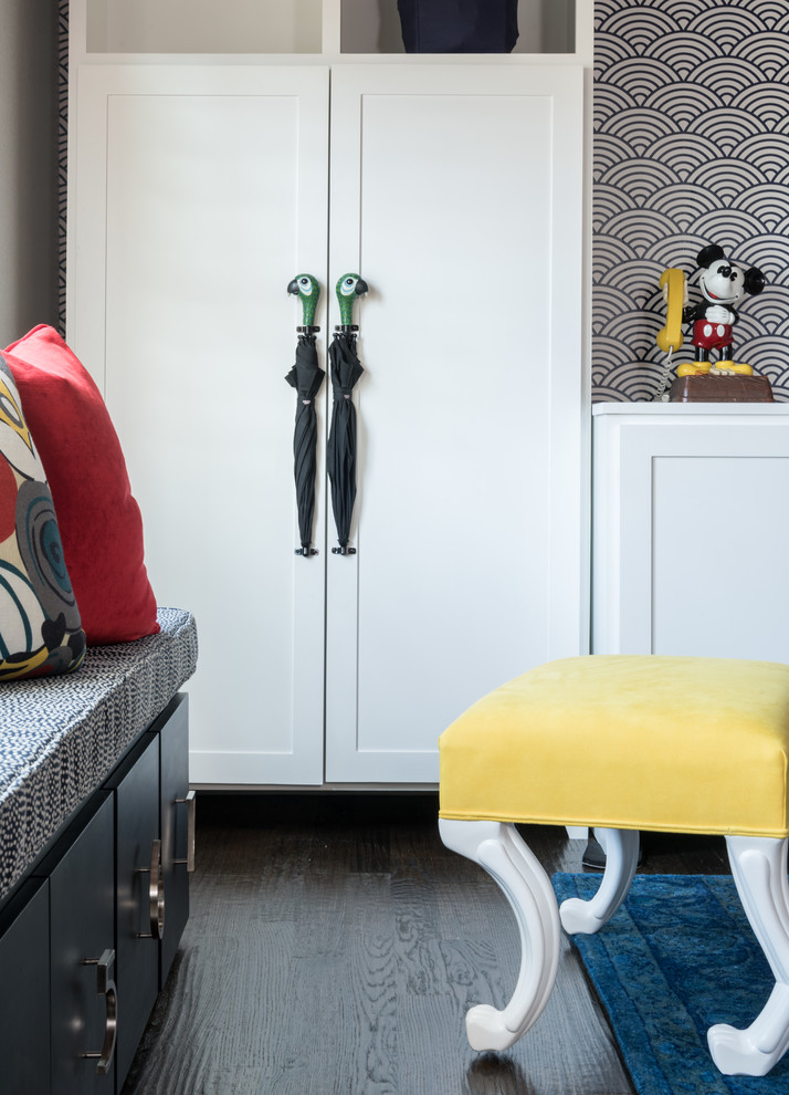 This is an example of a large gender-neutral kids' playroom for kids 4-10 years old in Dallas with grey walls, dark hardwood floors and brown floor.