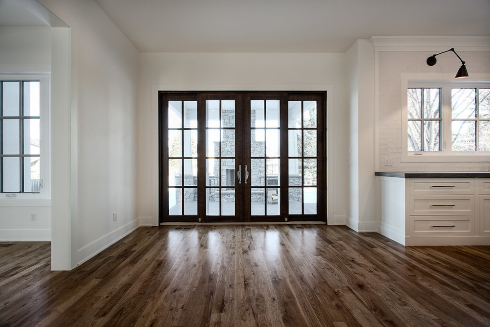 Large transitional u-shaped eat-in kitchen photo in Calgary with shaker cabinets, paneled appliances and an island