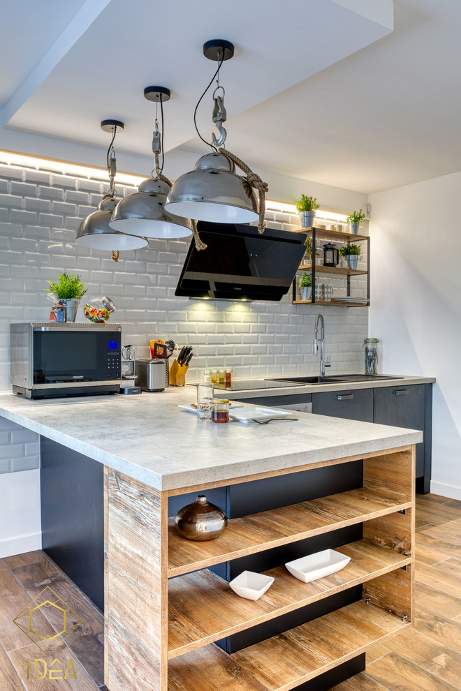 Design ideas for an industrial l-shaped separate kitchen in Paris with with island.