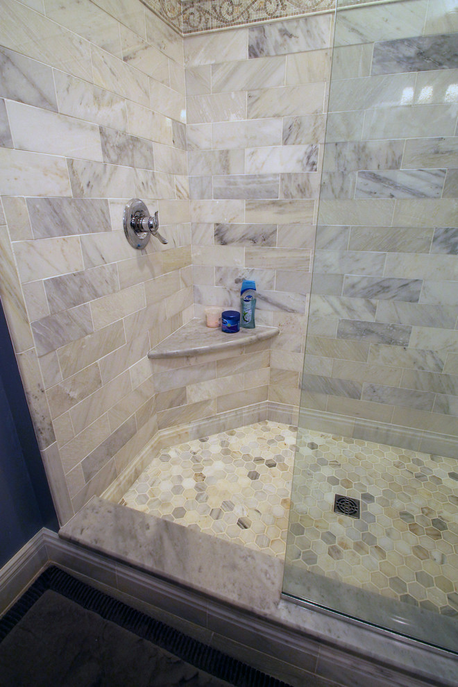 Photo of a small eclectic master bathroom in Philadelphia with recessed-panel cabinets, white cabinets, an open shower, a wall-mount toilet, gray tile, stone tile, grey walls, porcelain floors, an undermount sink and marble benchtops.
