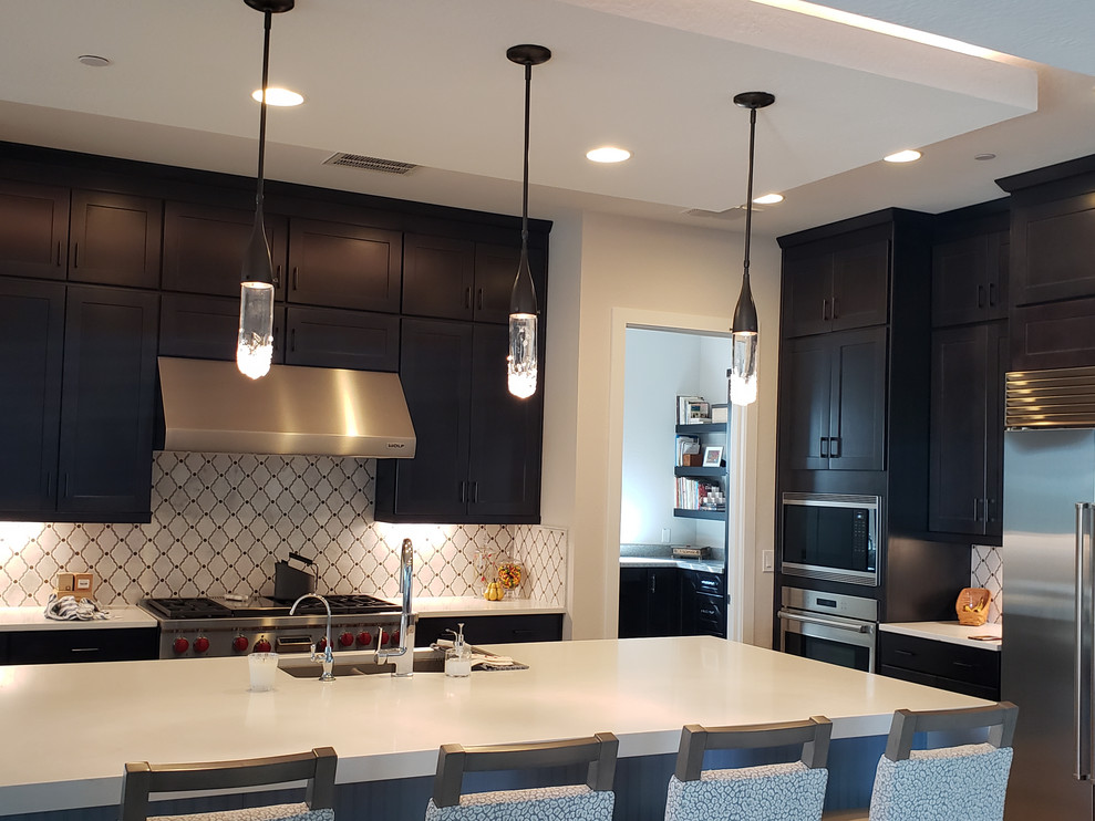 Huge transitional porcelain tile eat-in kitchen photo in Phoenix with an undermount sink, shaker cabinets, dark wood cabinets, quartz countertops, multicolored backsplash, mosaic tile backsplash, stainless steel appliances, an island and white countertops