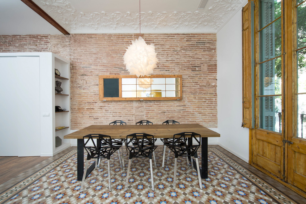 This is an example of a mid-sized industrial dining room in Barcelona with white walls, ceramic floors and no fireplace.