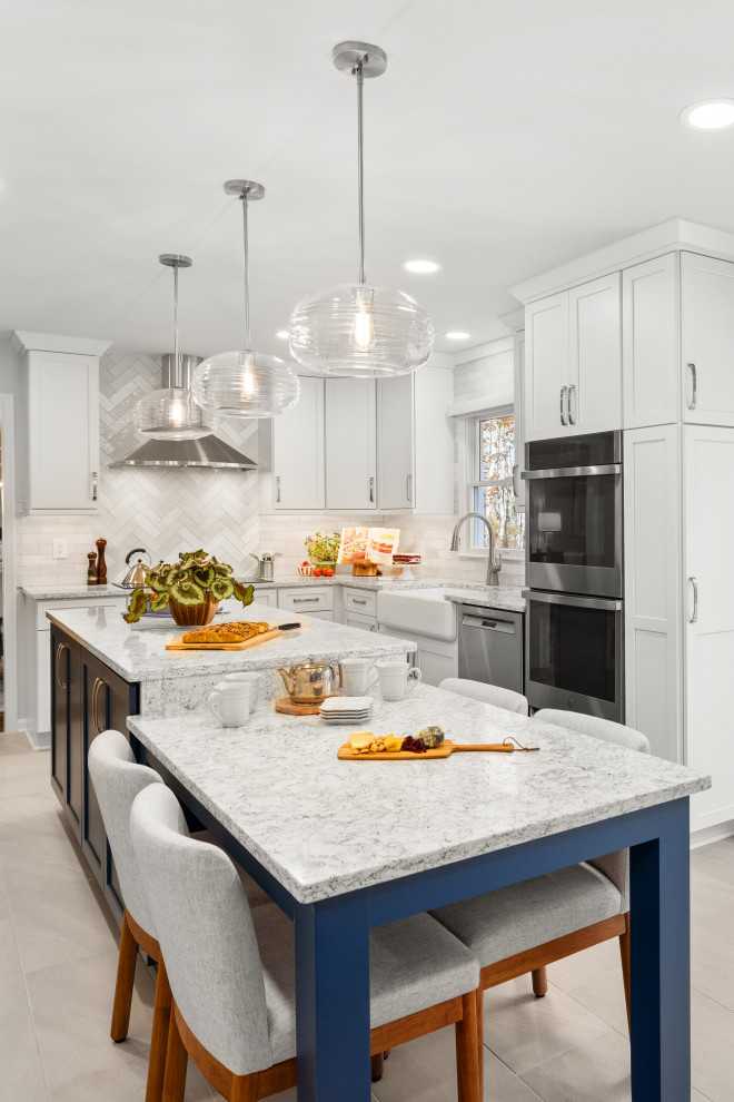 Inspiration for a medium sized classic kitchen in DC Metro with shaker cabinets, white cabinets, engineered stone countertops, porcelain splashback, stainless steel appliances, an island and grey floors.