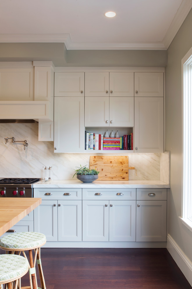 Inspiration for a beach style kitchen in San Francisco with recessed-panel cabinets, dark hardwood floors, with island, marble benchtops and marble splashback.