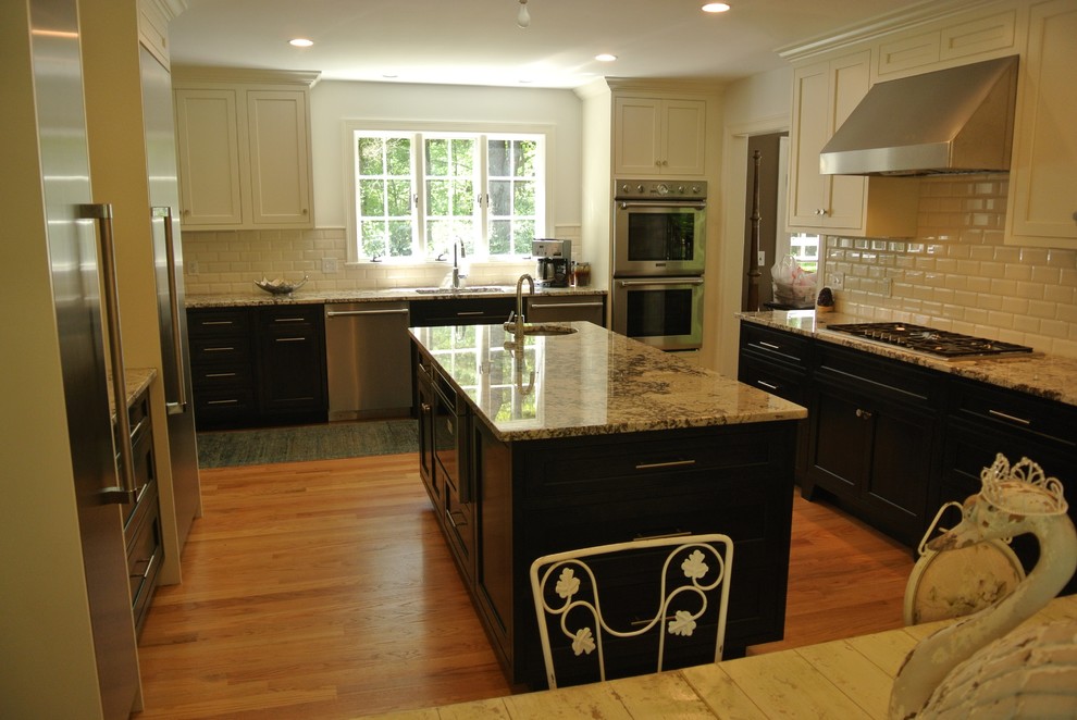 Eat-in kitchen - transitional light wood floor eat-in kitchen idea in Boston with an undermount sink, shaker cabinets, granite countertops, white backsplash, subway tile backsplash, stainless steel appliances and an island