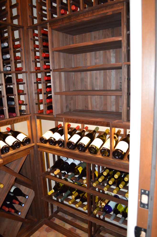 Design ideas for a mid-sized country wine cellar in Orange County with display racks.