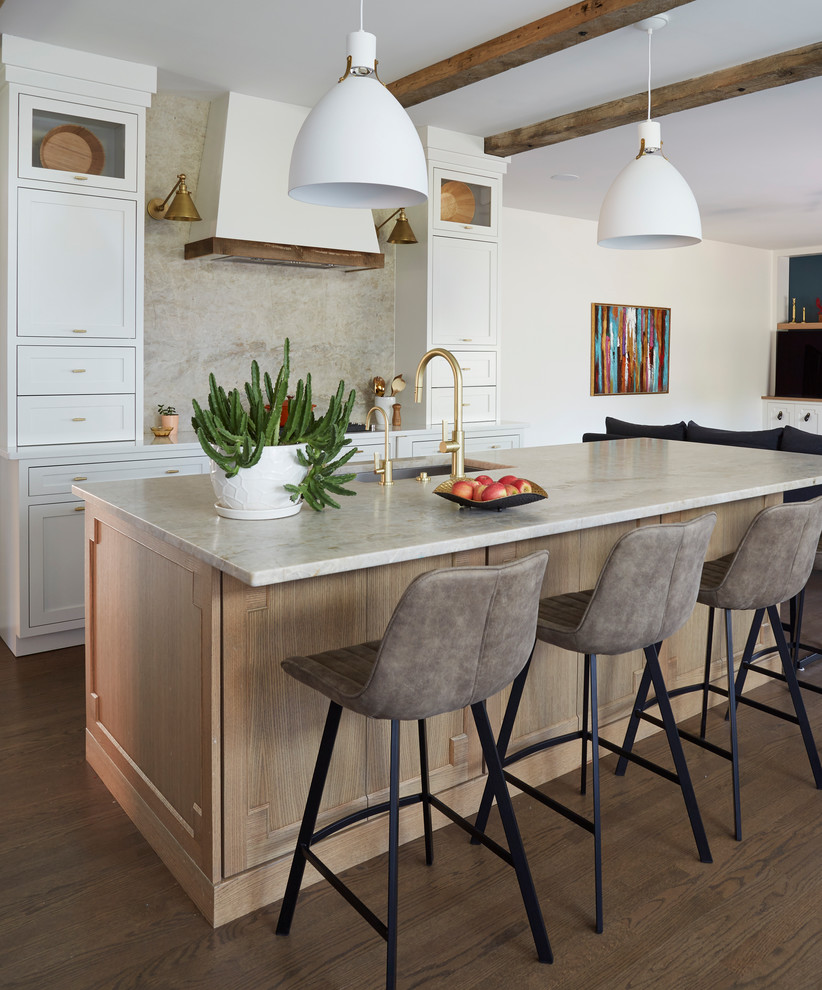 Inspiration for a transitional galley dark wood floor and brown floor open concept kitchen remodel in Chicago with an undermount sink, shaker cabinets, white cabinets, beige backsplash, stone slab backsplash, an island and white countertops