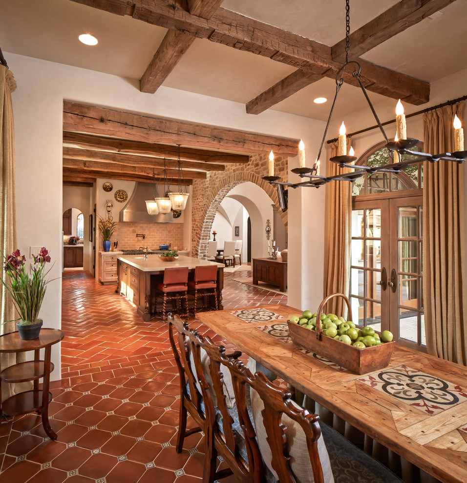 Inspiration for a large mediterranean kitchen/dining combo in Houston with beige walls, terra-cotta floors, no fireplace and red floor.