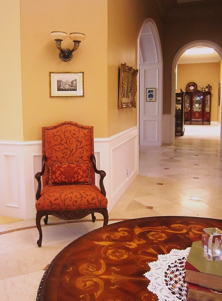 Photo of a large traditional hallway in San Diego with yellow walls, porcelain floors and multi-coloured floor.