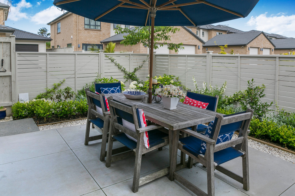 Photo of a small traditional backyard patio in Auckland with concrete pavers.