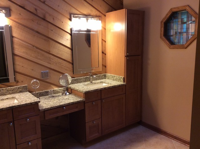 This is an example of a bathroom in Chicago with shaker cabinets, medium wood cabinets, beige walls, an undermount sink and granite benchtops.