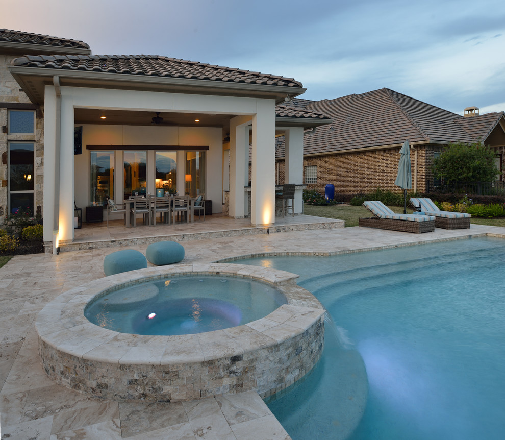 Large transitional backyard custom-shaped natural pool in Houston with a hot tub and natural stone pavers.