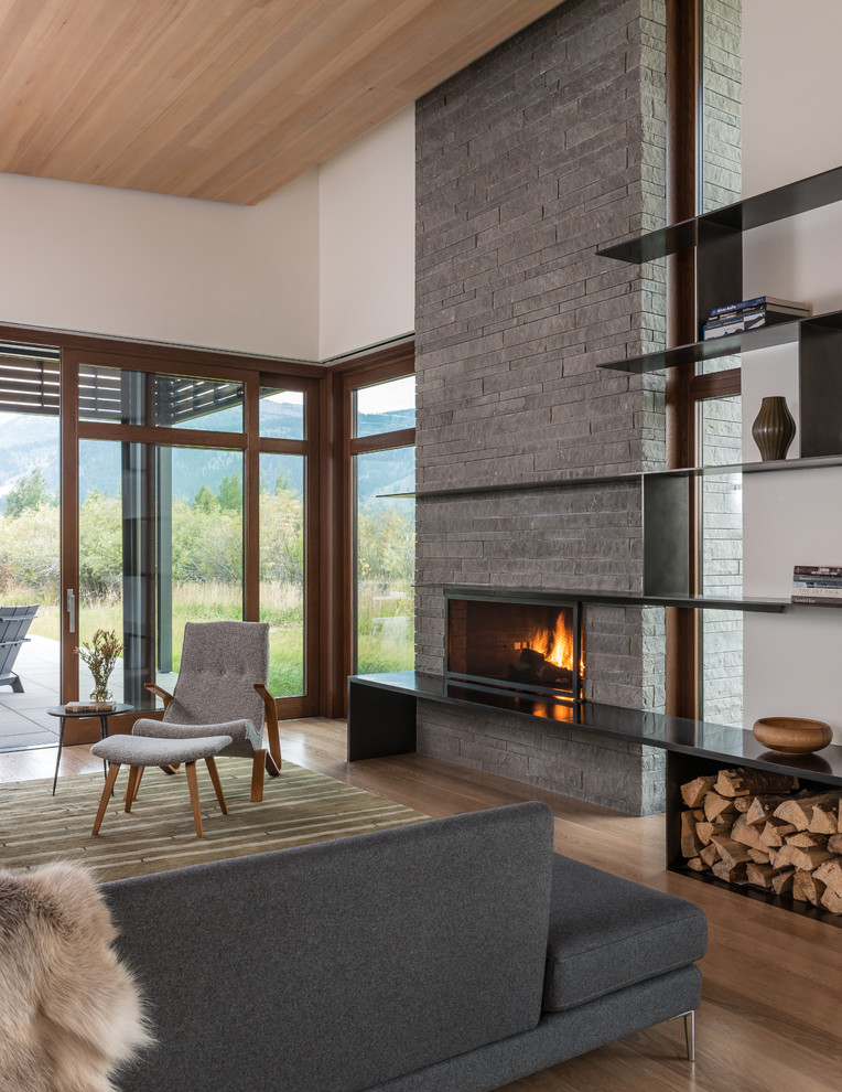 Design ideas for a contemporary open concept living room in Salt Lake City with white walls, medium hardwood floors, a standard fireplace and a stone fireplace surround.