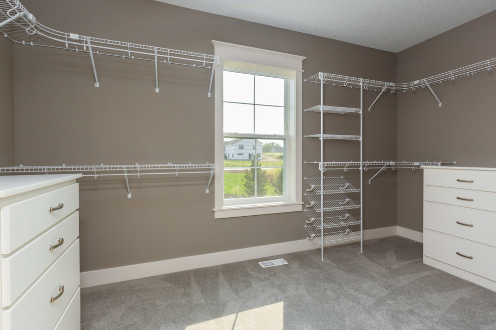Inspiration for a transitional gender-neutral carpeted walk-in closet remodel with flat-panel cabinets and white cabinets