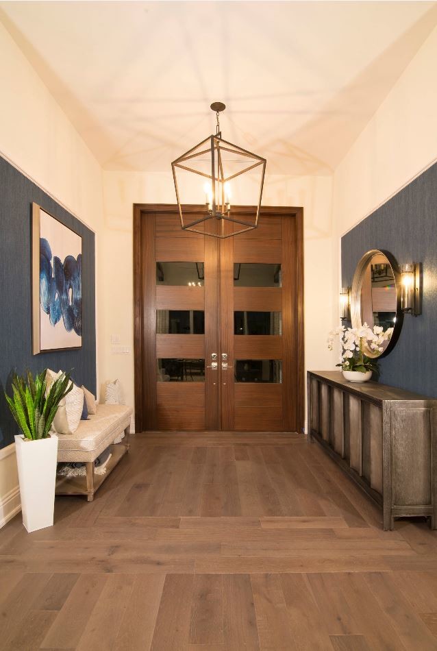 Large beach style foyer in Miami with beige walls, medium hardwood floors, a double front door, a brown front door and brown floor.