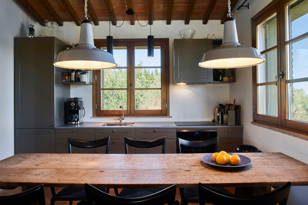 Small country single-wall eat-in kitchen in Florence with an undermount sink, recessed-panel cabinets, grey cabinets, panelled appliances, no island, grey benchtop and wood.