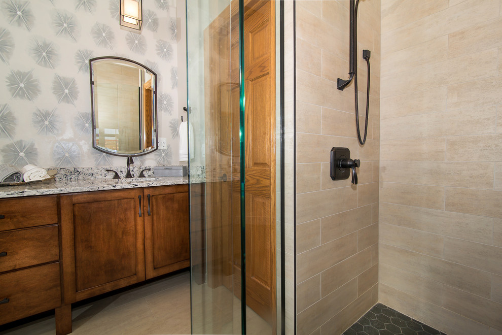 Freestanding bathtub - mid-sized transitional master beige tile and porcelain tile porcelain tile and beige floor freestanding bathtub idea in Denver with raised-panel cabinets, medium tone wood cabinets, multicolored walls, an undermount sink and granite countertops