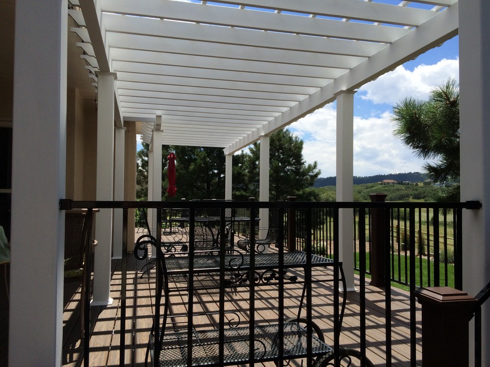Example of a mid-sized transitional backyard deck design in San Diego with a pergola