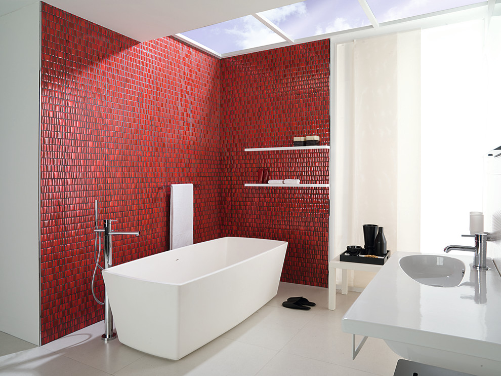 This is an example of a modern bathroom in Orange County with a freestanding tub, red tile and red walls.