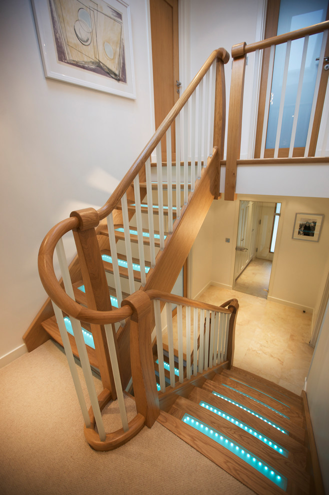 Design ideas for a large transitional wood u-shaped staircase in Other with open risers.