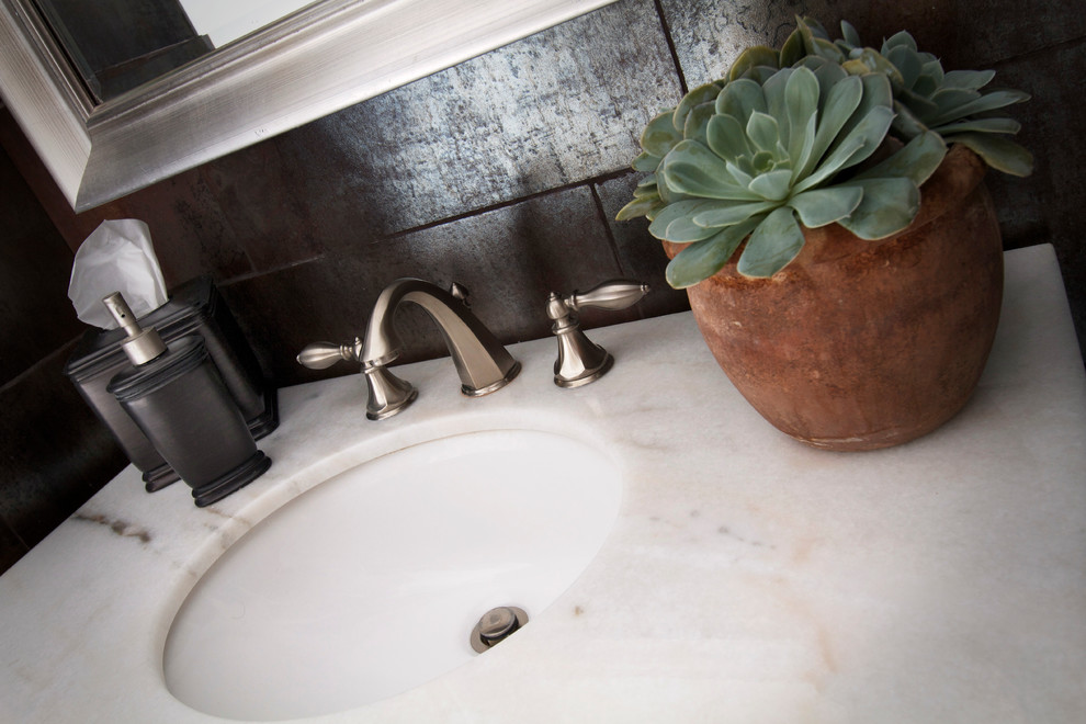 Inspiration for a small transitional brown tile and porcelain tile marble floor bathroom remodel in Phoenix with dark wood cabinets, quartzite countertops and brown walls
