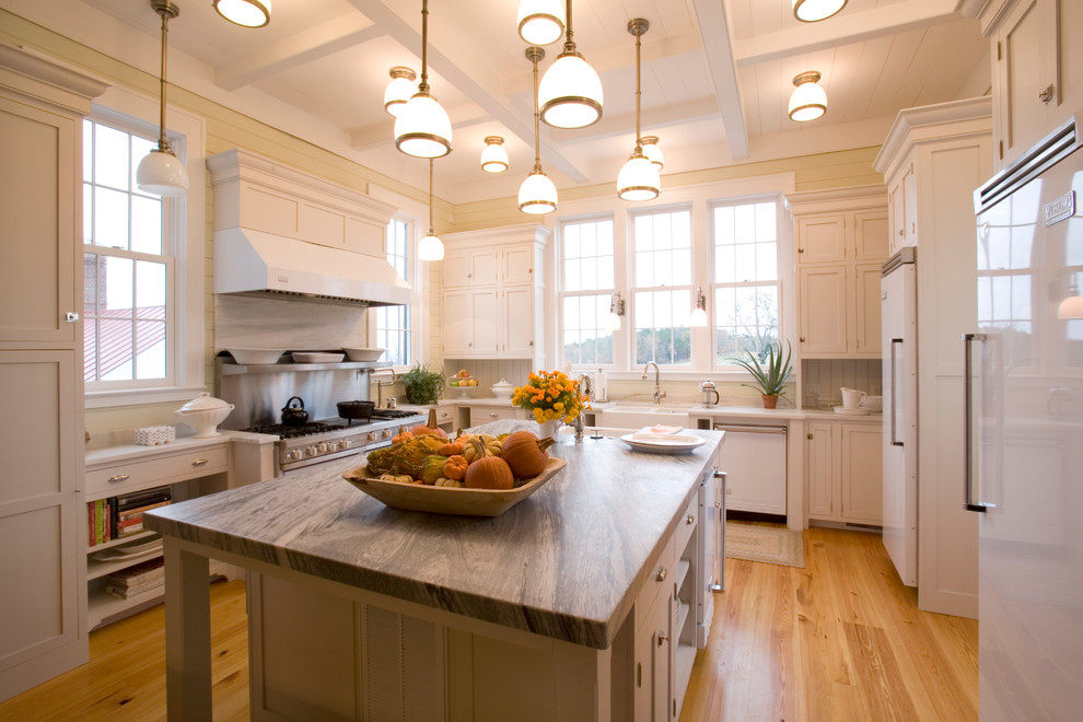 This is an example of a traditional u-shaped separate kitchen in Little Rock with a farmhouse sink, shaker cabinets, white cabinets and white appliances.